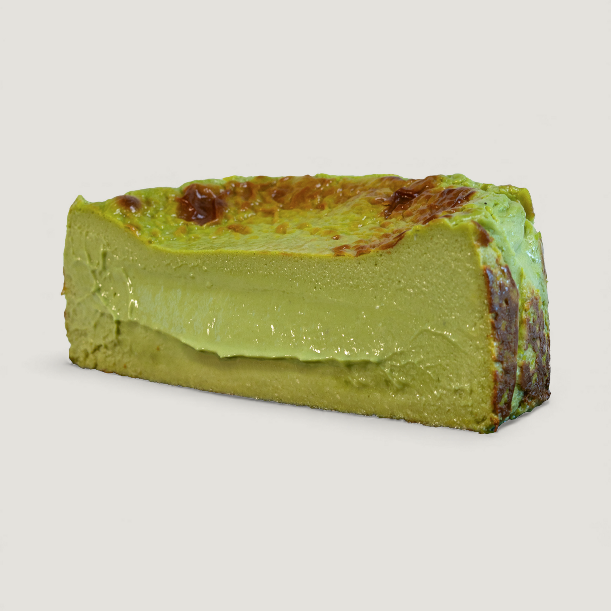 Handmade Matcha Basque cheesecake cut with caramelized top and creamy center – Bite Cheesecakes San Diego