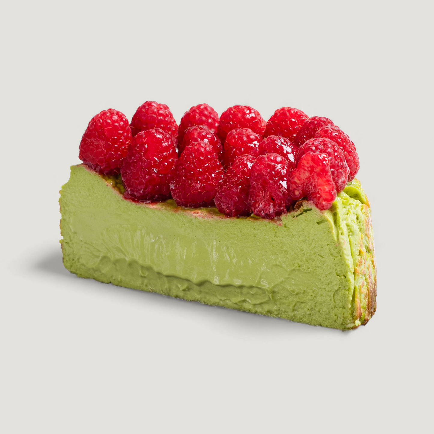 Matcha Basque cheesecake Slice with raspberries and caramelized top – handmade in San Diego